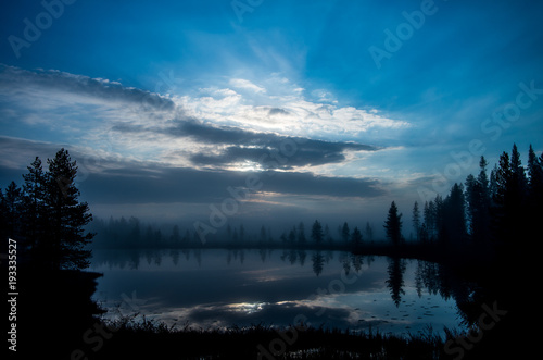 Serene  blue moment over a small lake in Lapland  Finland