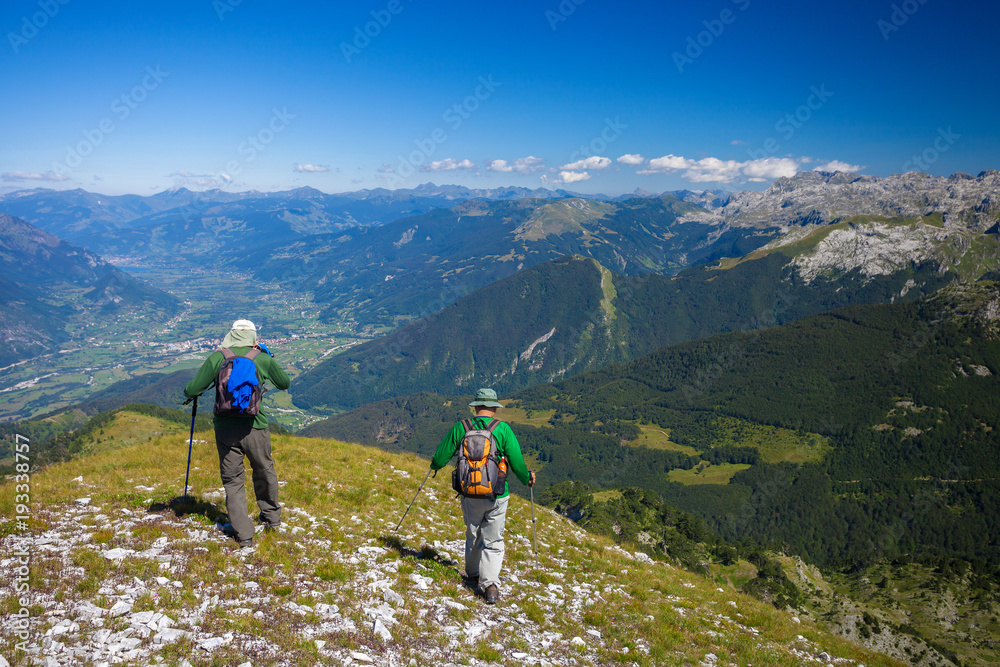 Two hikers with backpacks in the mountains of Montenegro. View from Trojan peak