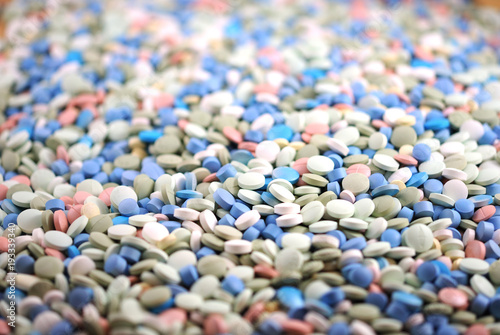 Multicolored round tablets closeup background