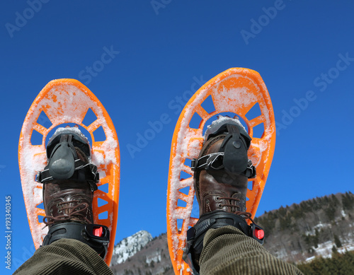 two orange snowshoes in winter
