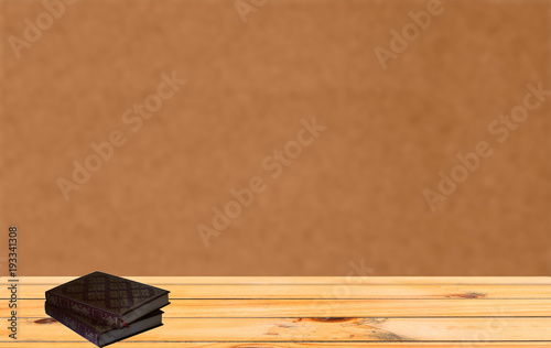 Book on a wooden table with orange background