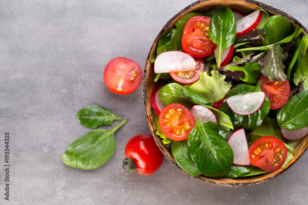 Fresh salad with baby spinach and tomatoes, radish und salad.
