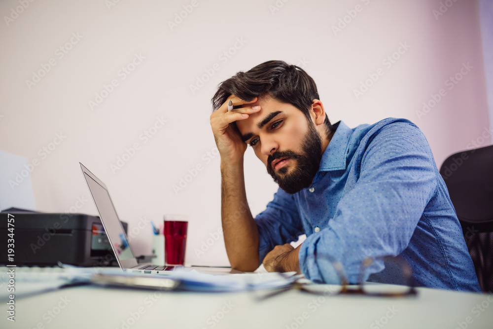 Young worried businessman holding his head. Young worried businessman holding his head.