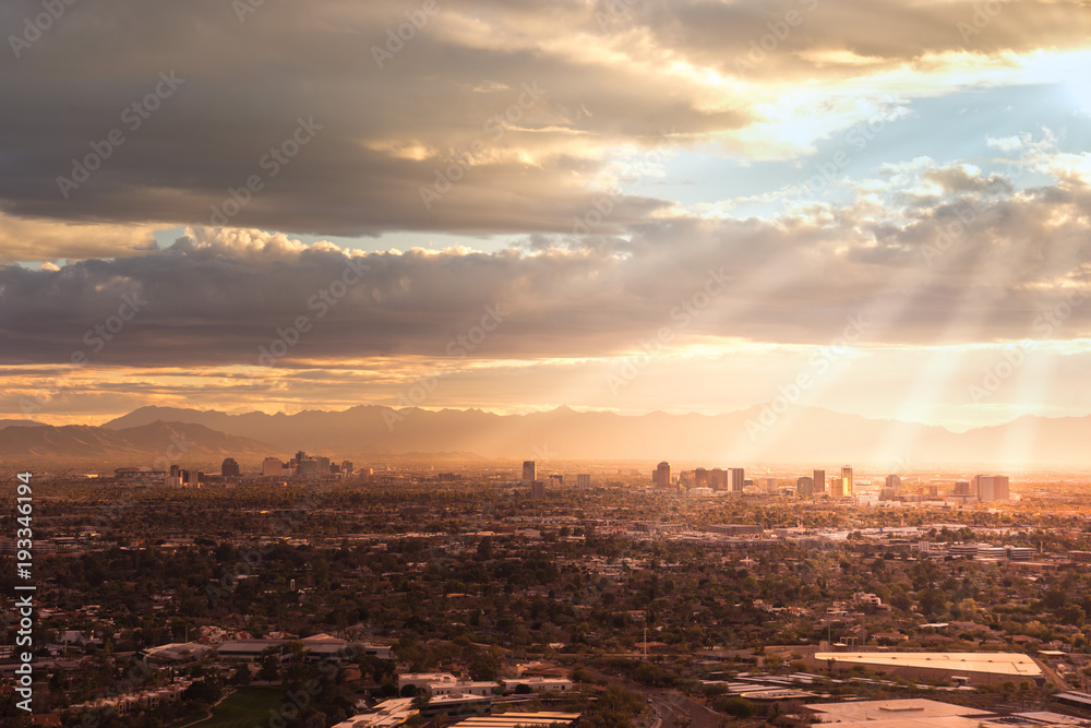 Phoenix,Az,USA; Aerial view of the downtown area, sun rays peaking through clouds.