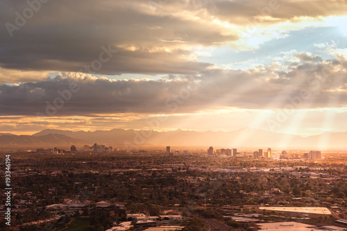Phoenix Az USA  Aerial view of the downtown area  sun rays peaking through clouds.