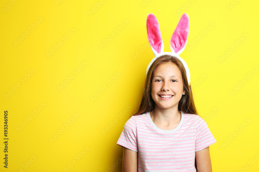 Portrait of beautiful girl with rabbit ears on yellow background Portrait of beautiful girl with rabbit ears on yellow background