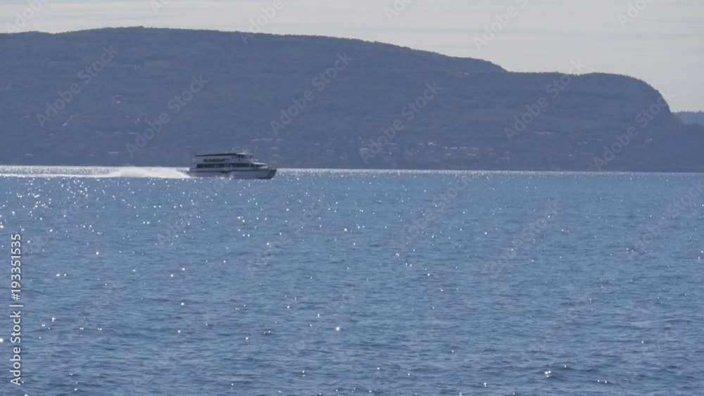 Boat trip on Lake Garda, in northern Italy. Crystal clear water, surrounded by mountains.