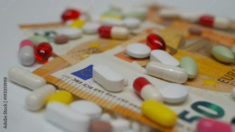 Euro and colourful pills turning around white background Euro and colourful pills turning around white background