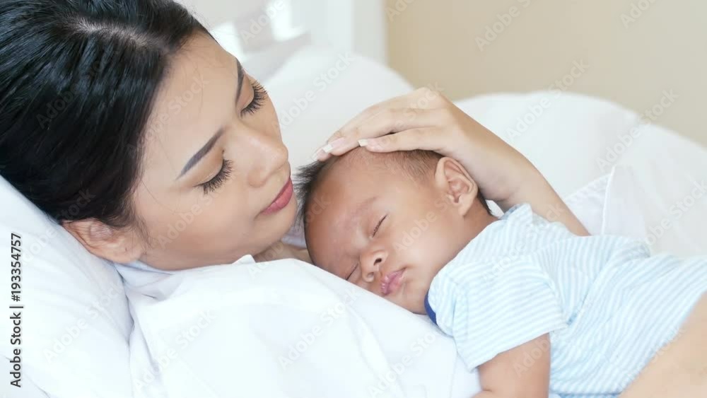 Young asian mother holding with her baby at home. Young asian mother holding with her baby at home.