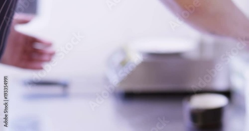 4K Professional chef preparing gourmet starter dish in restaurant kitchen. Close up on hands, no faces can be seen. photo