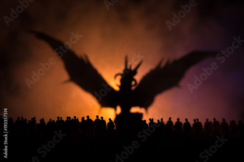 Blurred silhouette of giant monster prepare attack crowd during night. Selective focus. Decoration