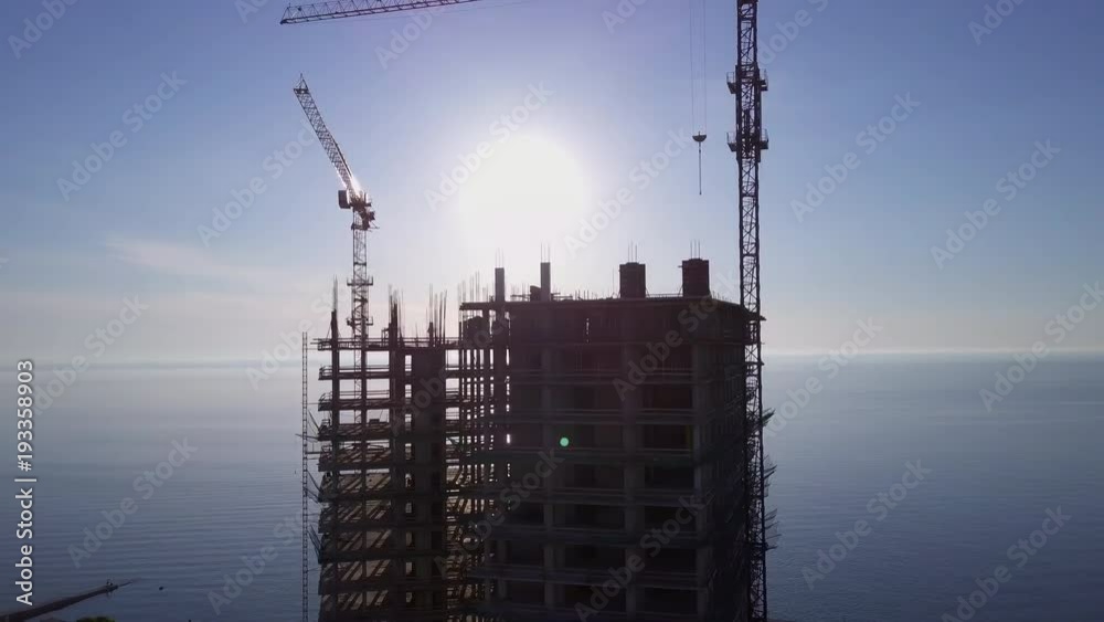 Round view of building a skyscraper background sea and sky sunset drone footage Round view of building a skyscraper background sea and sky sunset drone footage
