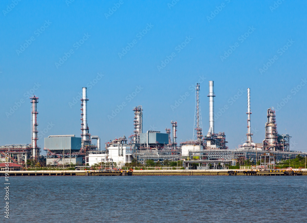 Oil and gas refinery with reflection in water - Petrochemical factory Oil and gas refinery with reflection in water - Petrochemical factory