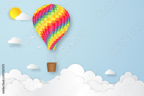 Colorful hot air balloon flying under blue sky and sunny as paper art, craft style and business new year start up concept. vector illustration.