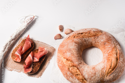 Traditional Galician white bread with moldy salami and jamon photo