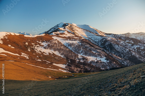 Mountains landscape at the evening. Caucasian mountains with snow caps, Arkhyz, Russia