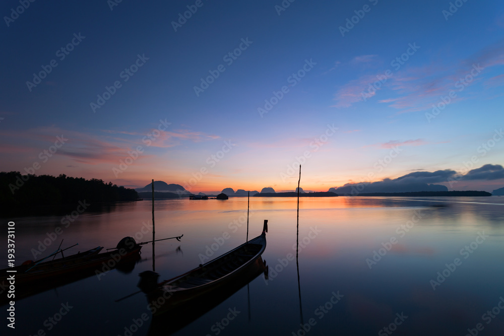 Longtail boat with coastal fishing village,Beautiful scenery view in morning sunrise over sea and mountain at phang - nga thailand