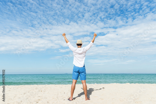 Happy lifestyle asian  man in sea beach, relax on the beach in summer. Travel Concept