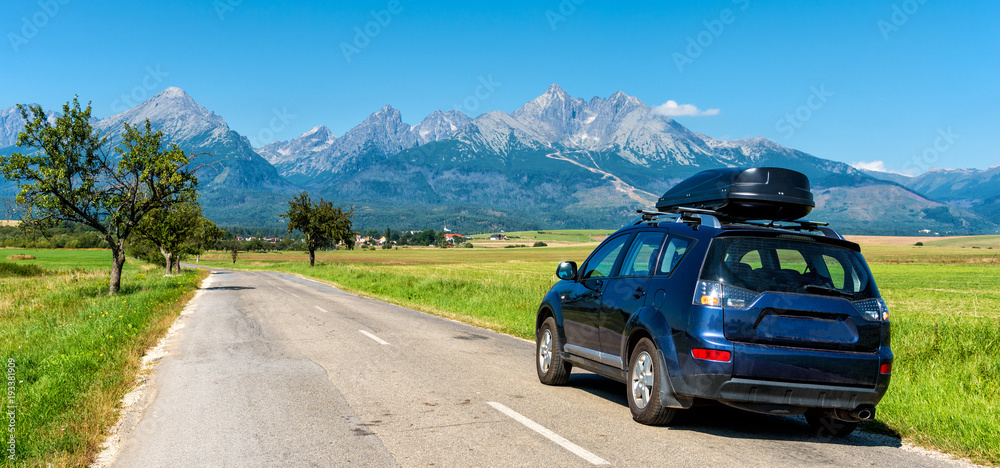 car for traveling with a roof rack on a mountain road