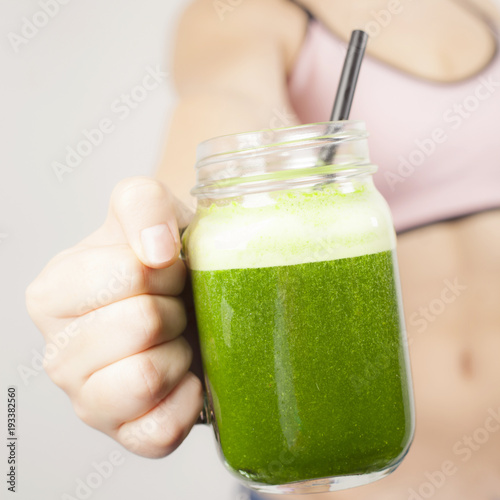 Teenage girl with green smoothie photo