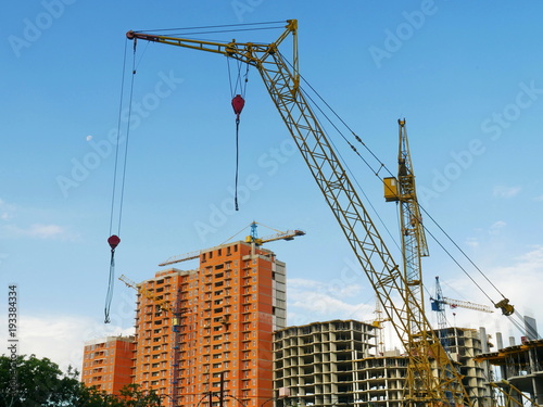 Сrane near building. Construction site. Buildings under construction.