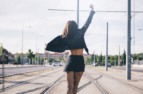 Young woman shouts and has fun via train arm up photo