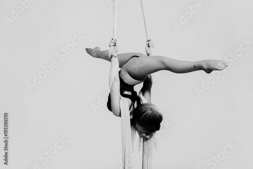 Close up image of sporty acrobatics. Hanging on silk tissue. photo