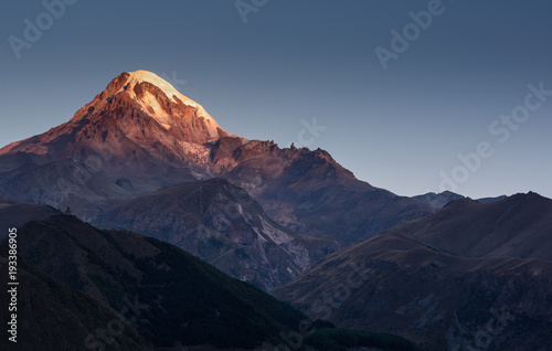 sunrise over Mount Kazbek in greater caucasus mountains