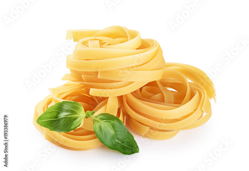 Photos Raw tagliatelle pasta and basil isolated on white background.