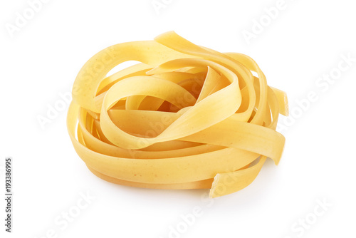 Raw tagliatelle pasta isolated on white background.