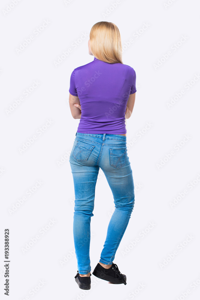 back view of standing young beautiful  woman.