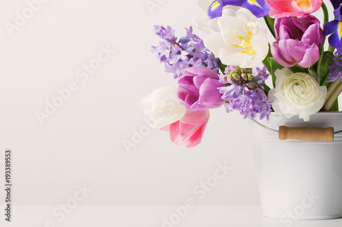 Fototapeta Naklejka Na Ścianę i Meble -  spring flowers in bucket on white  background