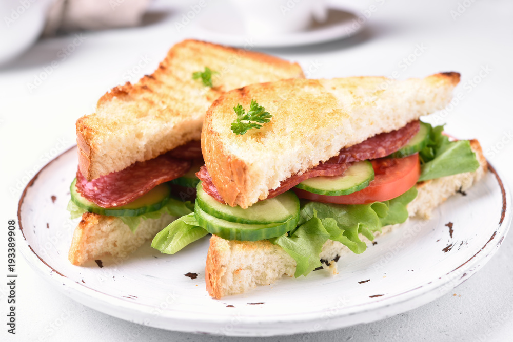 Sandwiches with salami, tomatoes, cucumber and lettuce Sandwiches with salami, tomatoes, cucumber and lettuce