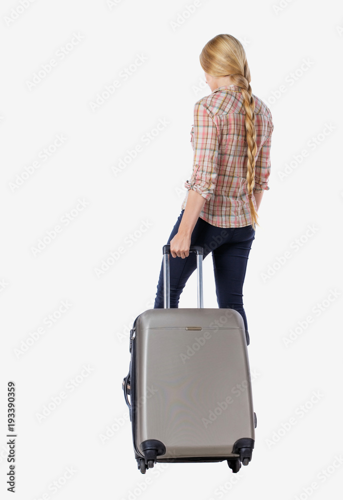 Back view of woman with suitcase looking up. Back view of woman with suitcase looking up.
