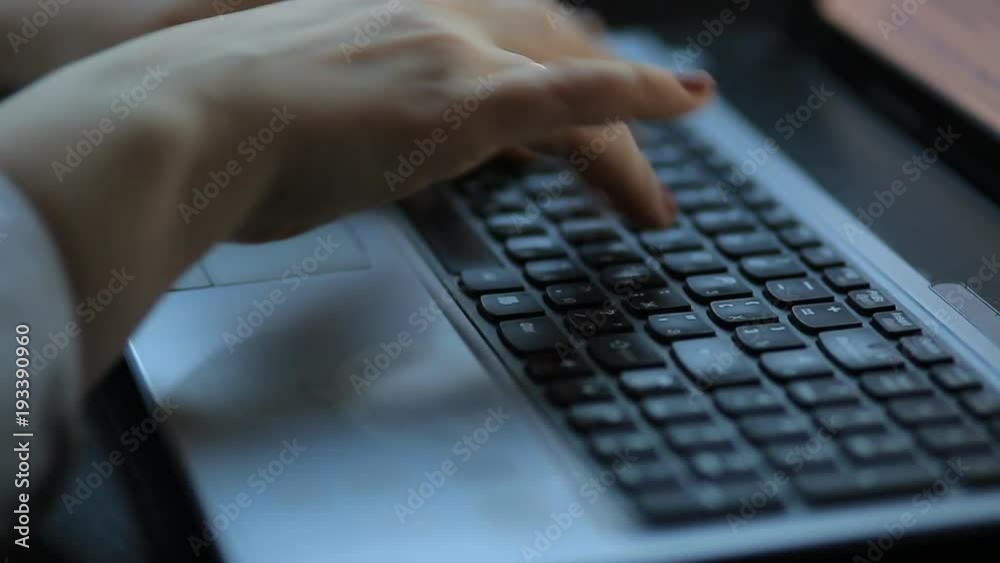 woman is typing on a laptop. Close-up woman is typing on a laptop. Close-up