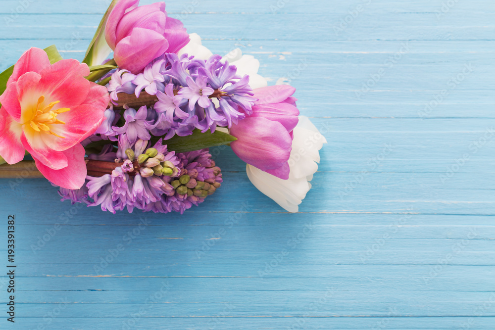 beautiful spring flowers on blue wooden background