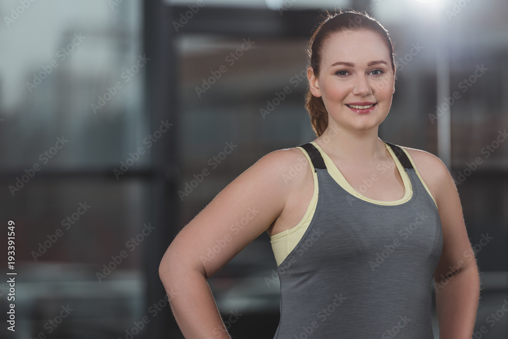 Portrait of obese girl smiling in gym