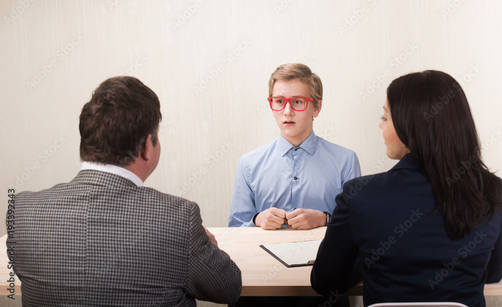 Young man during job interview and members of managemen Young man during job interview and members of managemen
