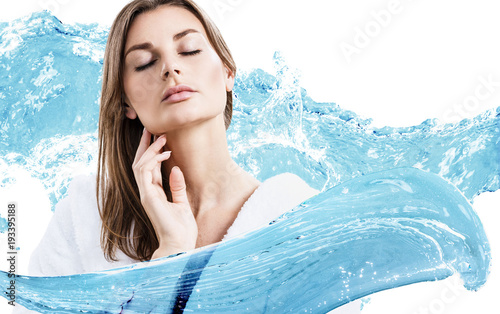 Young sensual woman in bathrobe in water splashes.