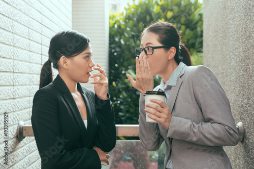 women talking about office gossip