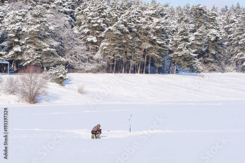 Protvino, Moscow region, Russia - February, 2, 2018: ice fishing on a frozen lake in Protvino, Moscow region, Russia photo