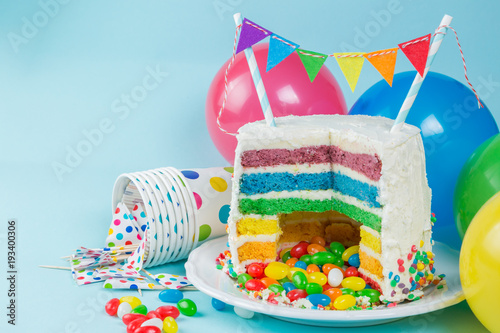 Rainbow pinata cake with candies - birthday background, card, concept