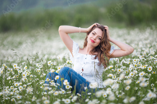 Beautiful happy smiling woman on the camomile field is wearing white dress, spring time © _chupacabra_