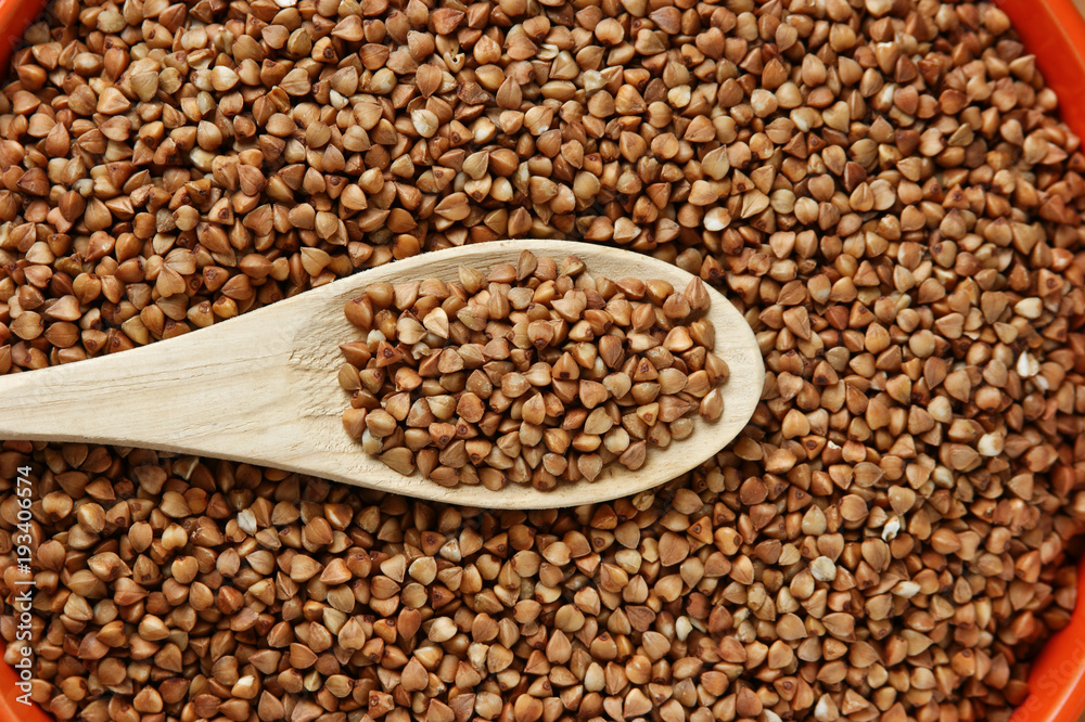 buckwheat groats and wooden spoon buckwheat groats and wooden spoon