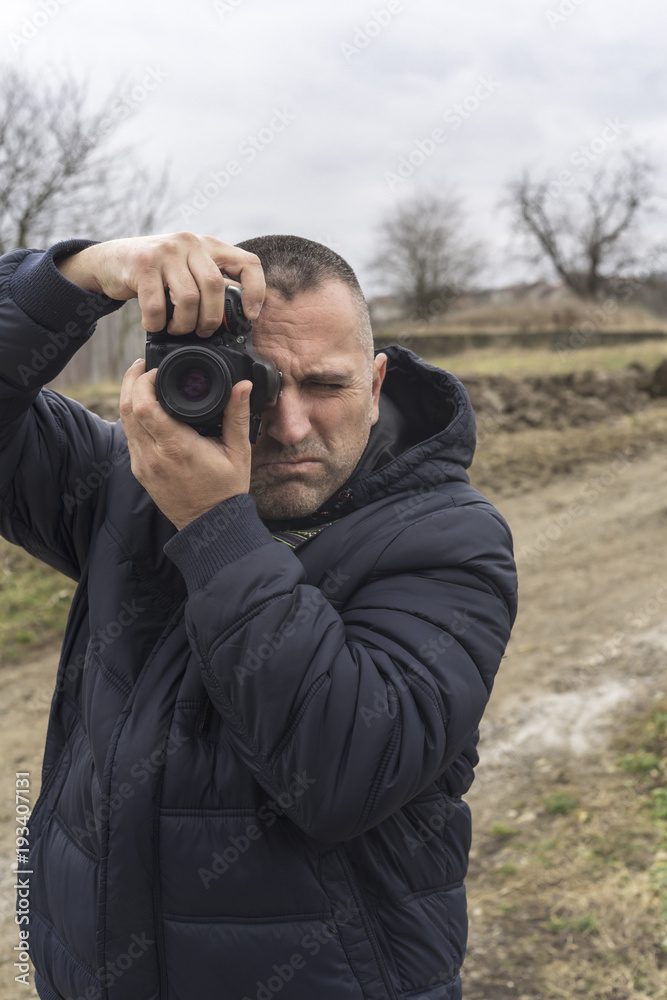 Photographer shooting outdoors scenery Photographer shooting outdoors scenery