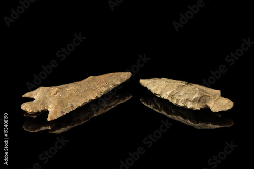 Foto Two Indian arrowheads and black background