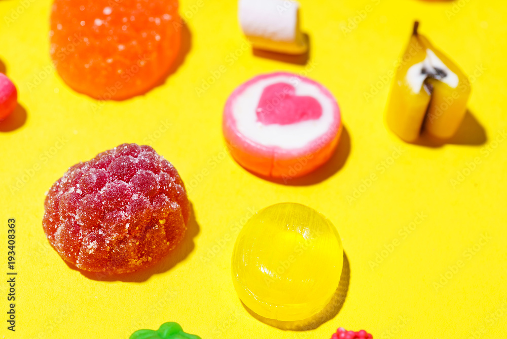colorful candy on the yellow background colorful candy on the yellow background