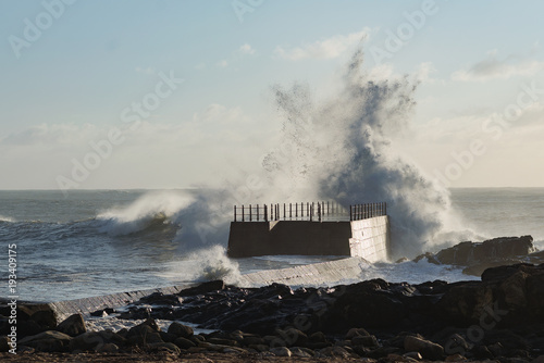 Rough sea coastline wave splash danger pier shore