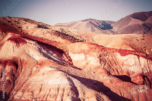 Colorful red rocks on a Sunny day. Beautiful view of the mountains of the Kyzyl-Chin, Altai. The Martian landscape of the canyon.