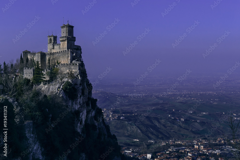 San Marino fortress landscape at dusk. Purple night sky - obrazy, fototapety, plakaty 